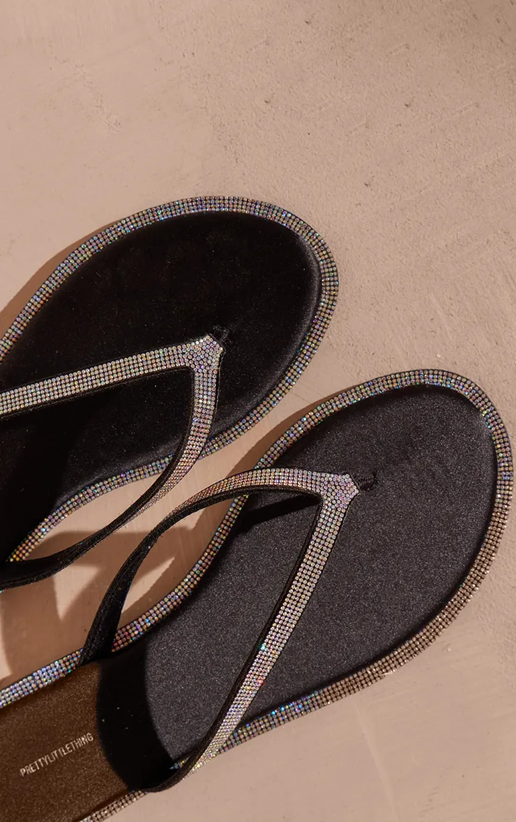 Sandales plates noires satinées à bout rond et rebords strass